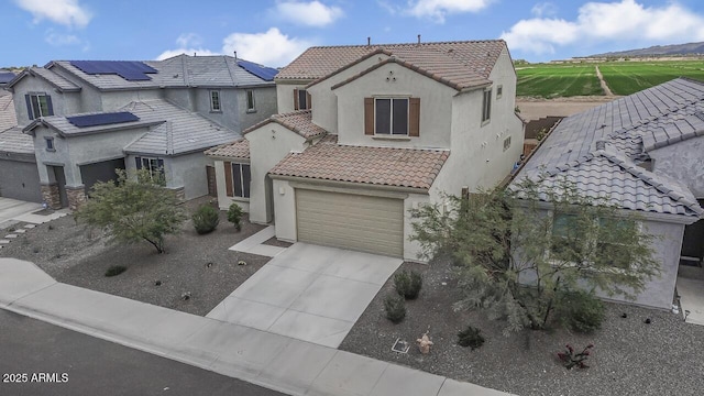 8521 S 67th Dr, Laveen, AZ 85339 - mediterranean / spanish home with stucco siding, driveway, a tiled roof, and an attached garage