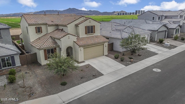 8521 S 67th Dr, Laveen, AZ 85339 - mediterranean / spanish house featuring a tile roof, driveway, stucco siding, fence, and a mountain view
