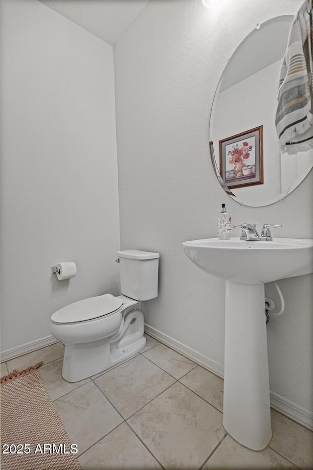 8521 S 67th Dr, Laveen, AZ 85339 - half bathroom with baseboards, toilet, and tile patterned flooring