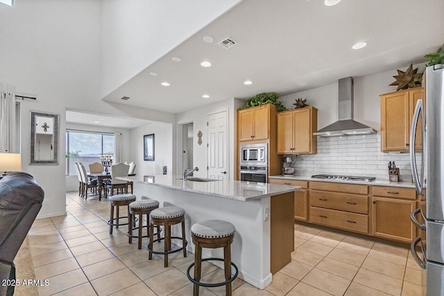 8521 S 67th Dr, Laveen, AZ 85339 - kitchen featuring wall chimney range hood, visible vents, light tile patterned flooring, and stainless steel appliances