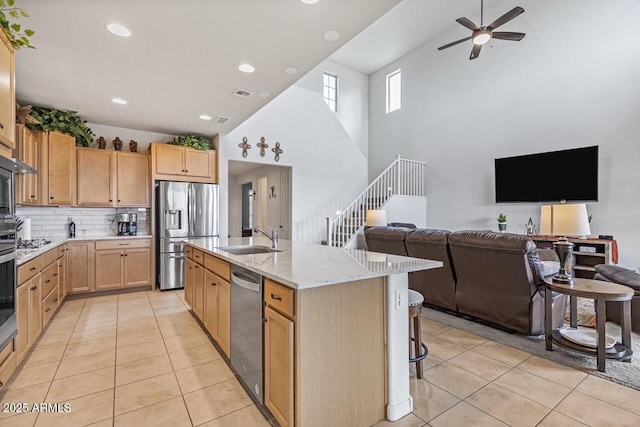 8521 S 67th Dr, Laveen, AZ 85339 - kitchen featuring open floor plan, light tile patterned floors, a sink, light brown cabinets, and appliances with stainless steel finishes