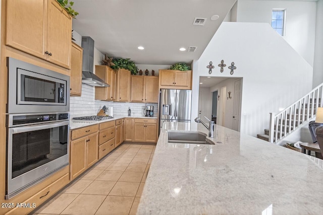 8521 S 67th Dr, Laveen, AZ 85339 - kitchen with light stone counters, a sink, wall chimney exhaust hood, stainless steel appliances, and visible vents
