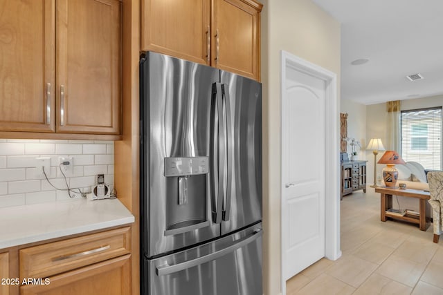 kitchen with tasteful backsplash and stainless steel fridge with ice dispenser