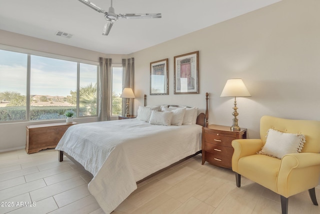 bedroom with a water view and ceiling fan