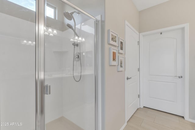 bathroom featuring a shower with door