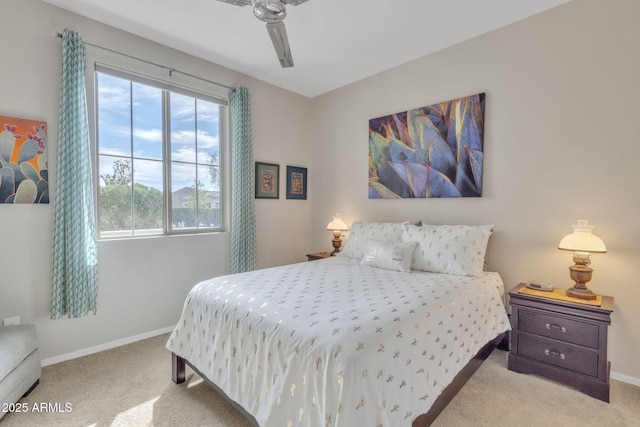 bedroom featuring light colored carpet and ceiling fan