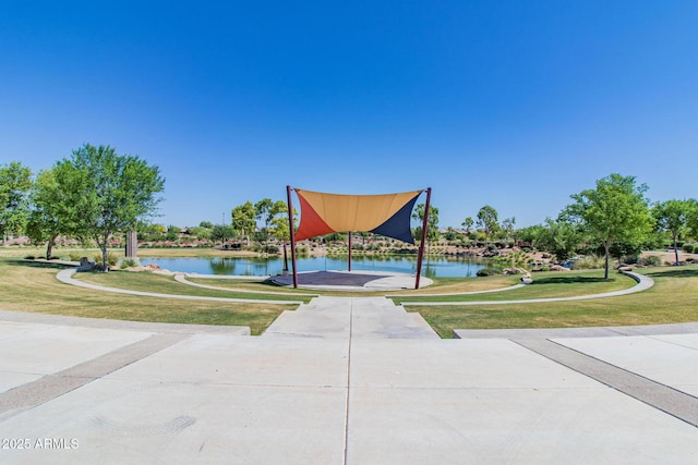 view of community with a lawn and a water view