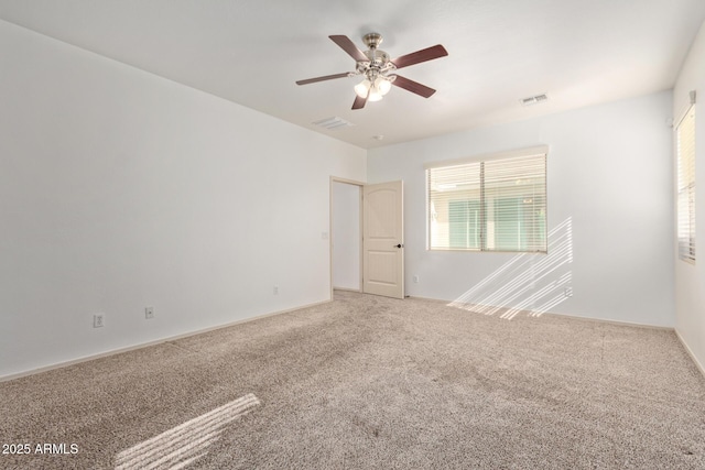 carpeted spare room with ceiling fan