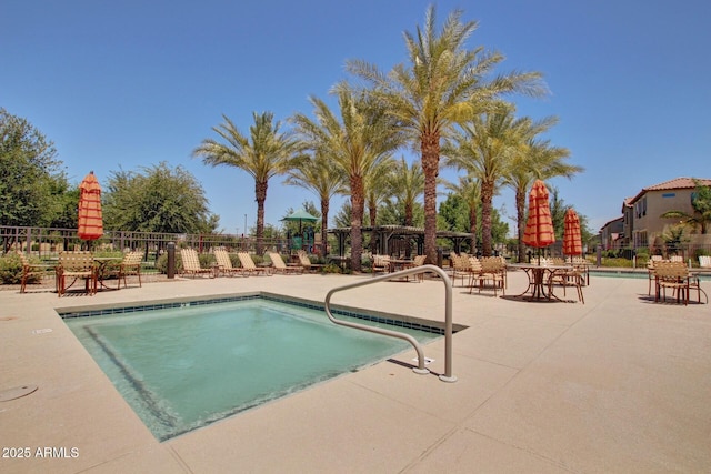 view of swimming pool featuring a patio area