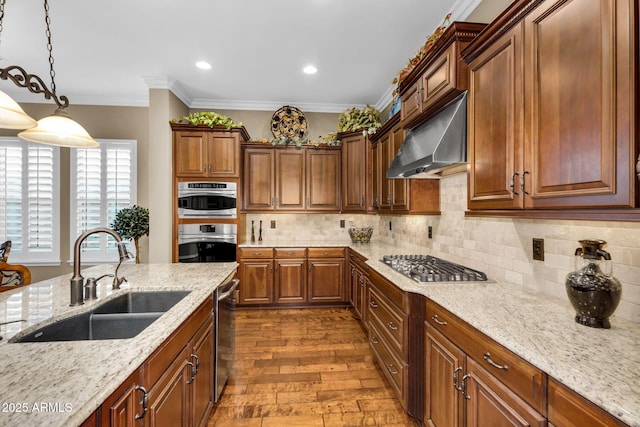 kitchen with ornamental molding, decorative backsplash, a sink, appliances with stainless steel finishes, and under cabinet range hood