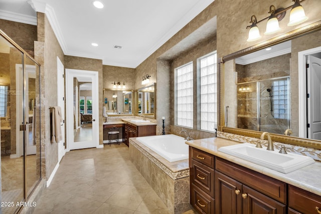 full bathroom featuring a garden tub, ornamental molding, a stall shower, and a sink