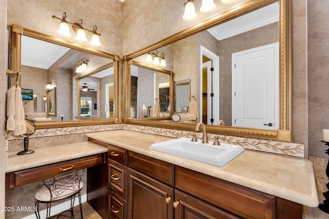 bathroom featuring vanity, crown molding, and ceiling fan