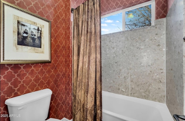 bathroom with shower / tub combo and toilet