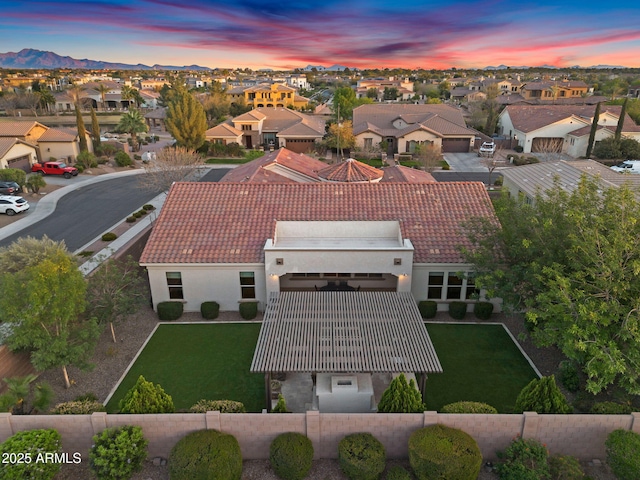 aerial view at dusk featuring a residential view