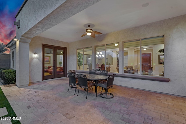 view of patio / terrace with outdoor dining space, french doors, and a ceiling fan