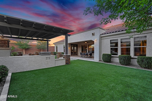 yard at dusk with a patio area, area for grilling, and a pergola