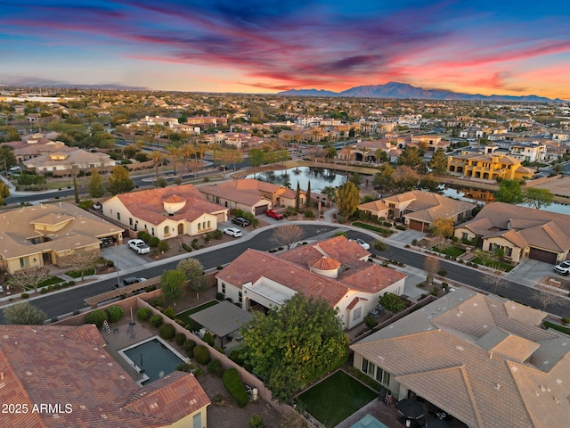 aerial view at dusk with a residential view and a water and mountain view