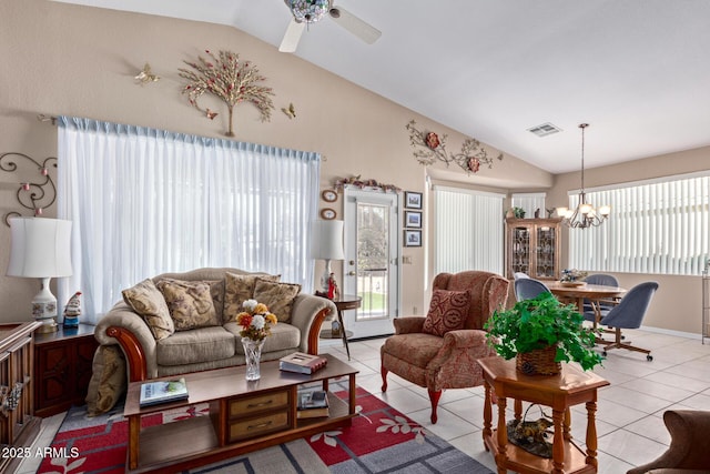 living room featuring lofted ceiling, light tile patterned flooring, and ceiling fan with notable chandelier