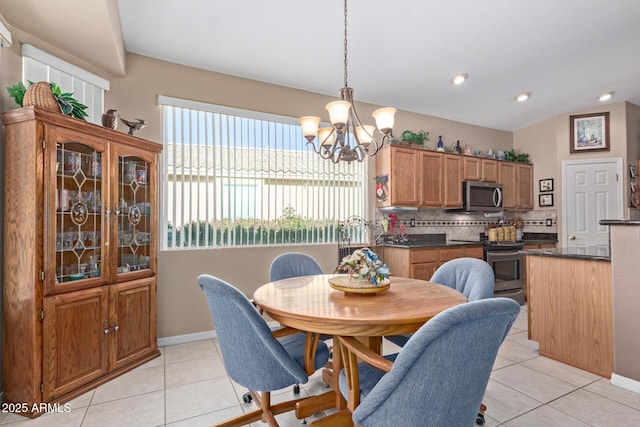 dining room with lofted ceiling, a notable chandelier, and light tile patterned flooring