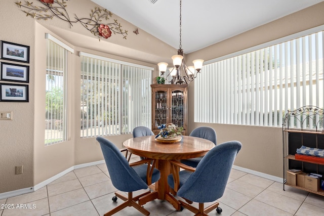 tiled dining room featuring lofted ceiling, a notable chandelier, and a healthy amount of sunlight