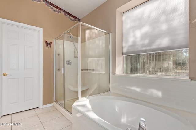 bathroom with tile patterned floors and shower with separate bathtub