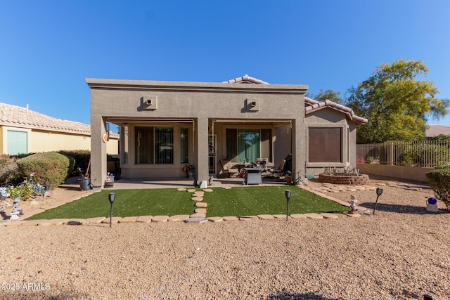 rear view of property featuring a patio