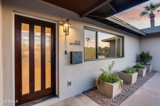 property entrance featuring stucco siding