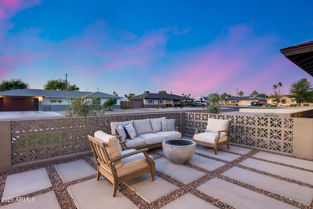 patio terrace at dusk with a residential view and an outdoor living space
