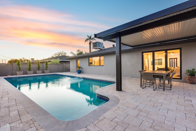 view of pool featuring a fenced in pool, fence, a patio, and outdoor dining space