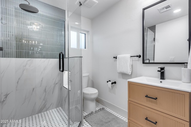 bathroom featuring toilet, baseboards, visible vents, and a marble finish shower