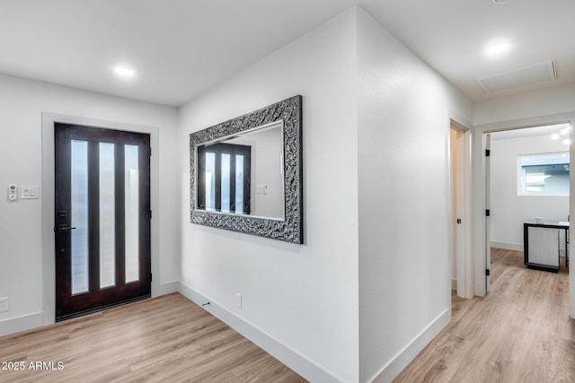 entrance foyer featuring baseboards and light wood-type flooring