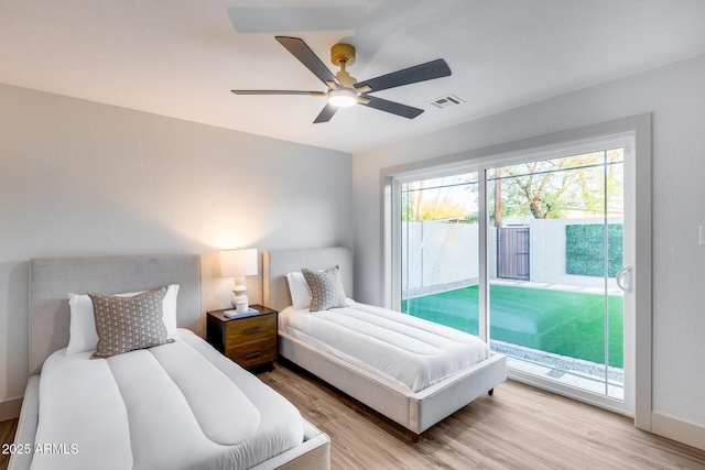 bedroom with access to outside, a ceiling fan, light wood finished floors, and visible vents