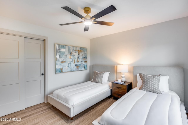 bedroom with light wood-type flooring and ceiling fan