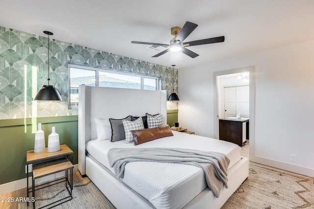 bedroom with baseboards, a ceiling fan, and connected bathroom