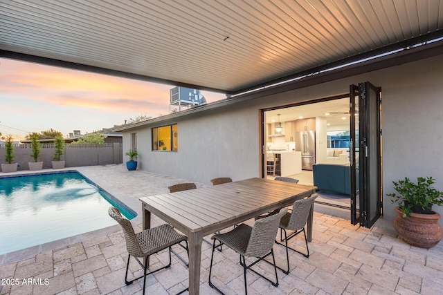 exterior space with a fenced in pool, a fenced backyard, and outdoor dining area