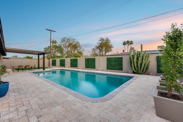 view of pool with a fenced in pool, a fenced backyard, and a patio area
