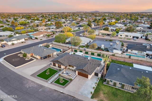 aerial view at dusk featuring a residential view
