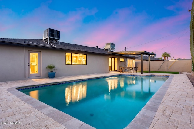 view of pool featuring a patio, a fenced in pool, central AC unit, and a fenced backyard