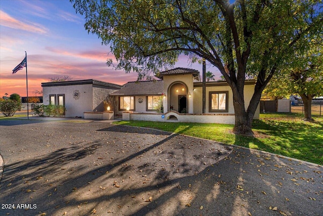 view of front of property with a yard