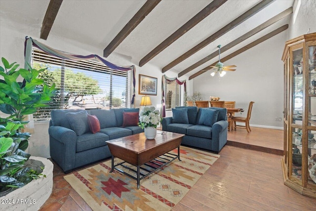 living room with ceiling fan, beamed ceiling, high vaulted ceiling, and hardwood / wood-style floors