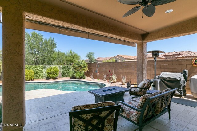 view of swimming pool featuring a grill, ceiling fan, and a patio