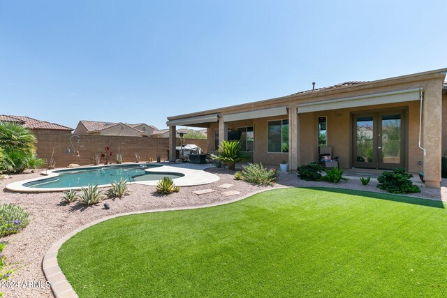 view of swimming pool featuring a yard and a patio