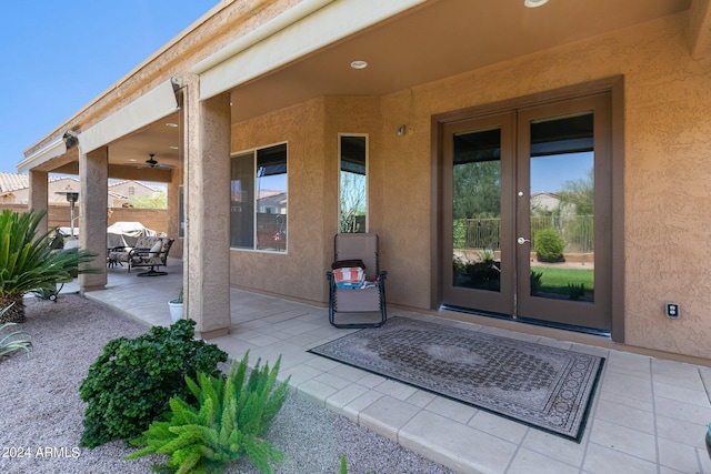 view of exterior entry featuring french doors and a patio