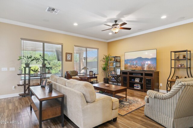 living room featuring ceiling fan, ornamental molding, and wood-type flooring