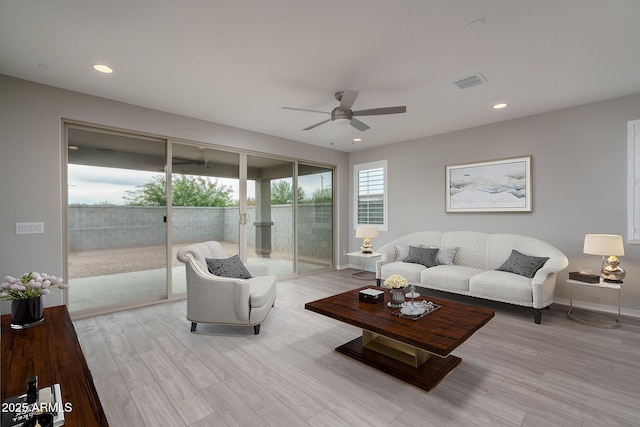 living room with ceiling fan and light wood-type flooring