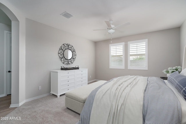 bedroom featuring light colored carpet and ceiling fan