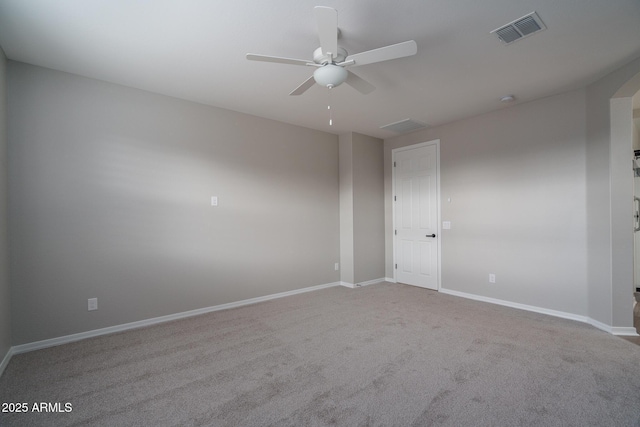 carpeted spare room featuring ceiling fan