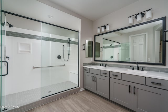 bathroom with tasteful backsplash, vanity, and an enclosed shower