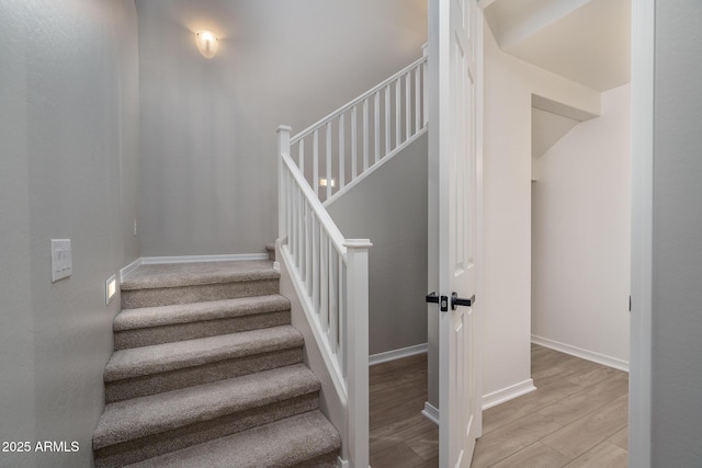 stairs featuring wood-type flooring