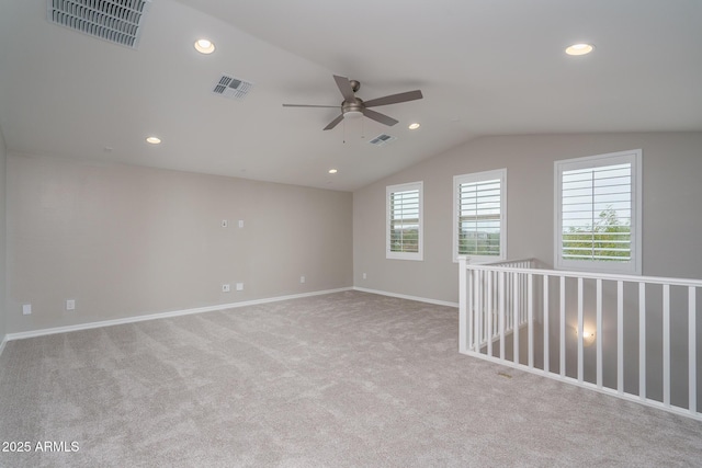 carpeted empty room with ceiling fan and lofted ceiling